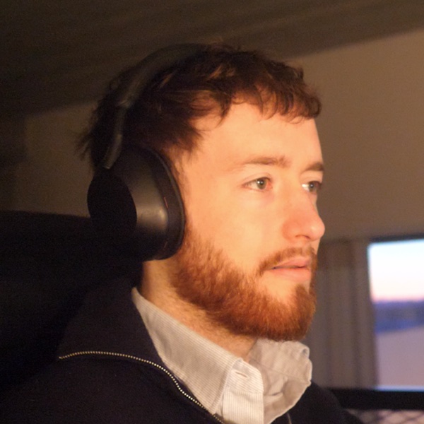 Bad profile photo: dark, headphones on, busy background